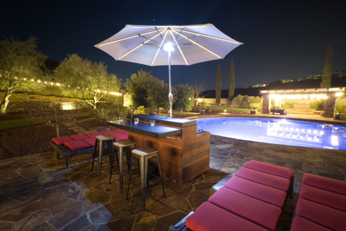 bar wiith umbrella by pool with tv lift cabinet