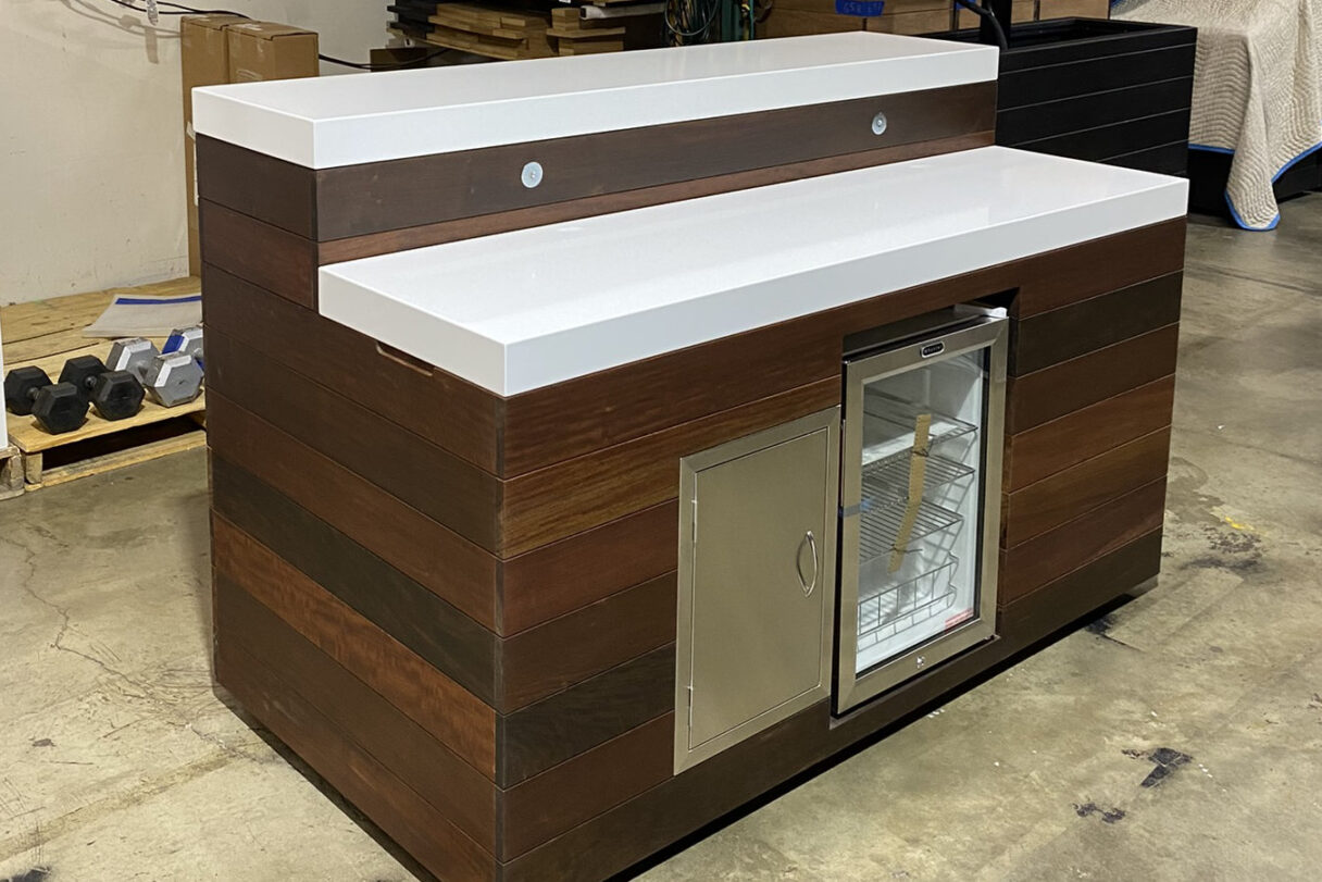 outdoor stunner with hidden bar tv lift cabinet and storage white top natural ipe stain