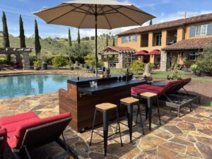 outdoor mobile cabinet bar with hidden tv lift seating area with umbrella