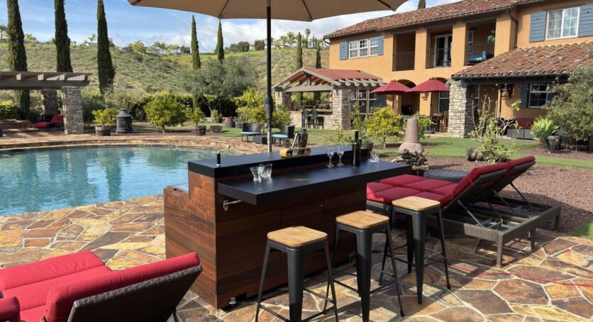 outdoor mobile cabinet bar with hidden tv lift seating area with umbrella