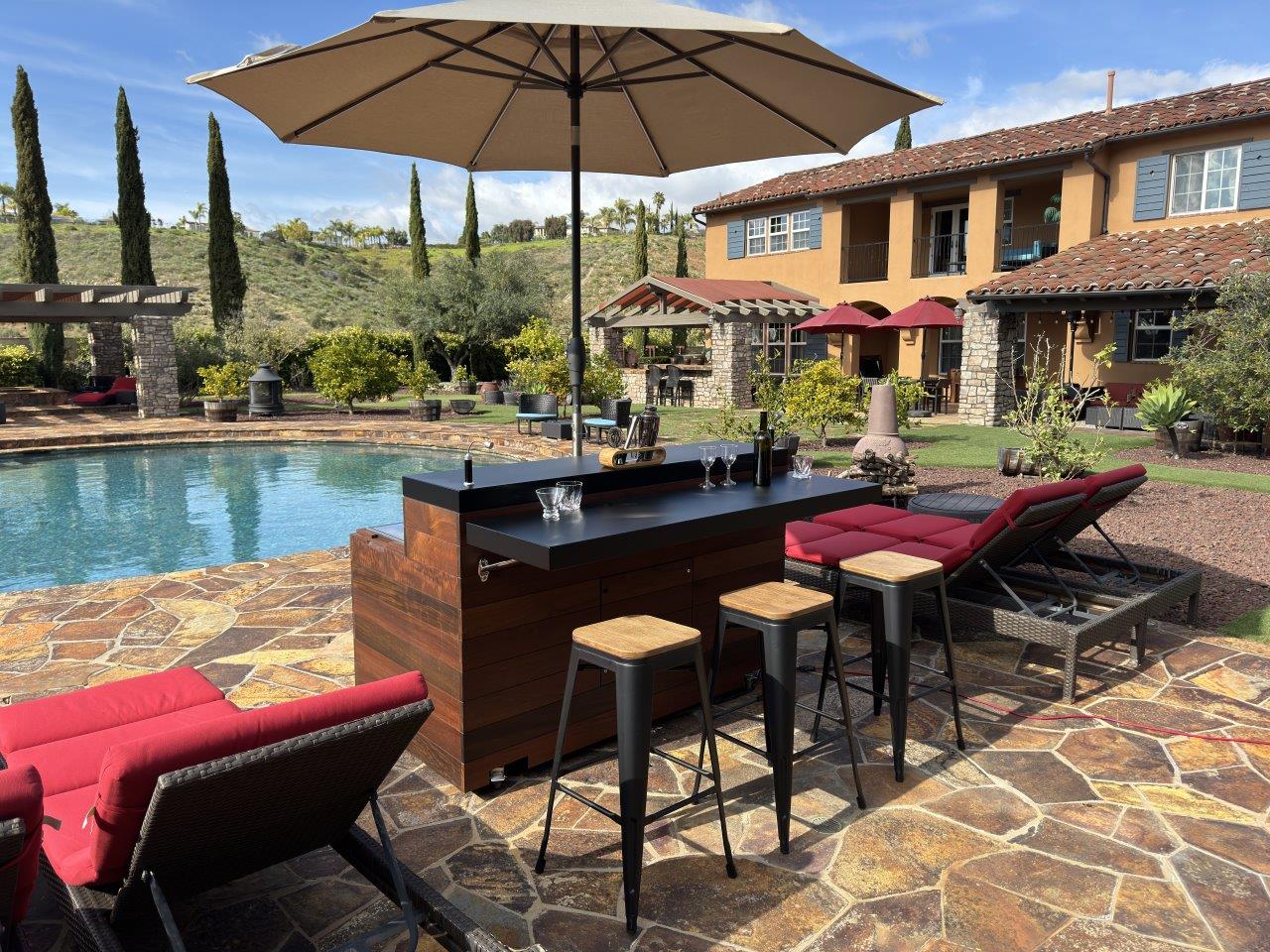 outdoor mobile cabinet bar with hidden tv lift seating area with umbrella