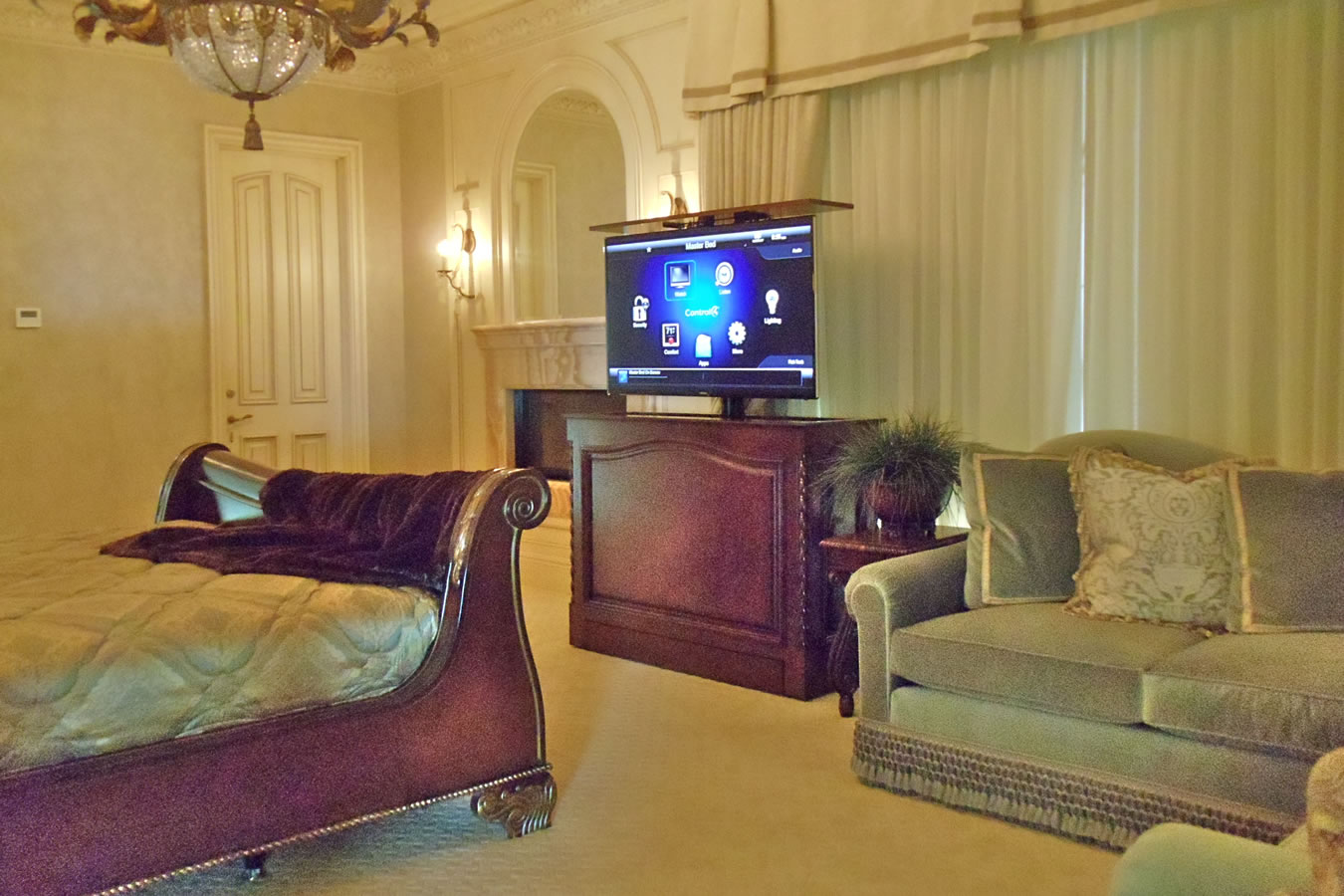 Beautiful bedroom that has a Cabinet Tronix Coronado TV lift furniture piece across from the bed.